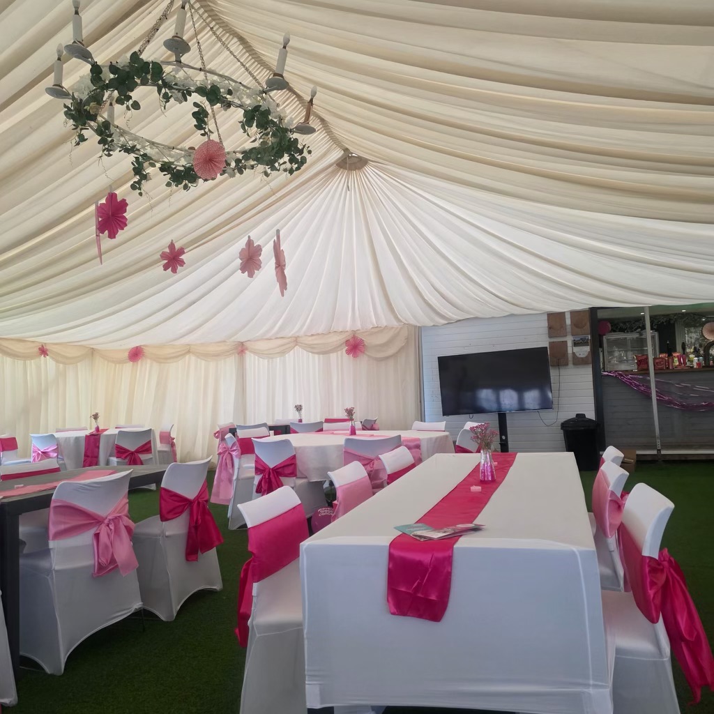 White Tables With Pink Ribbons In Outdoor Marquee 2